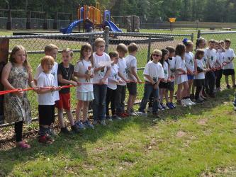  The first and second graders of West Fannin elementary were so excited for the Frog Bog to officially open. Shown, from left,  Lena Thomas, Titus Stanley, Joel Curtis, Kason Rogers, Autumn Blomeley, Ryles Thomas, Avery Anderson, Ronin Burke, Asher Stanton, Hayden Jones, Kaylin Postell, Ezra Loudermilk, Callie Mayfield, Bella Holloway, Ashlyn Jessen, Baker Born, and Oliver Herndon.