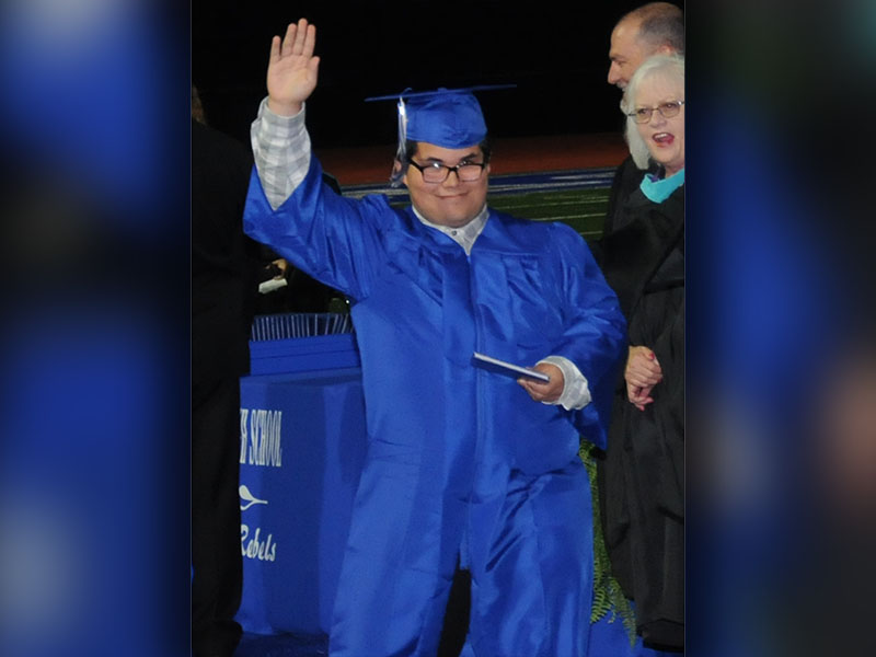 Joseph Fermin gave a big wave to the crowd as soon as he received his diploma Friday night on the Fannin County High School football field.