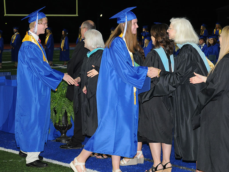 Class of 2022 graduates Anthony Covey and Rachel Bruce are congratulated after receiving their diplomas Friday night.